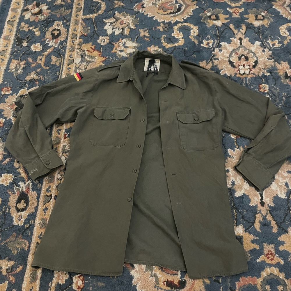 Army green button up jacket, Nirvana logo on back with German flags.
